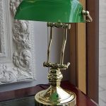 Brass Bankers lamp twin support with green glass shade, English .