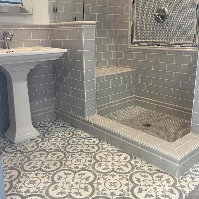 Modern hexagon and subway tile shower with a muted Spanish .