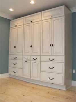Stock kitchen cabinets reused as a bedroom built in - great idea .