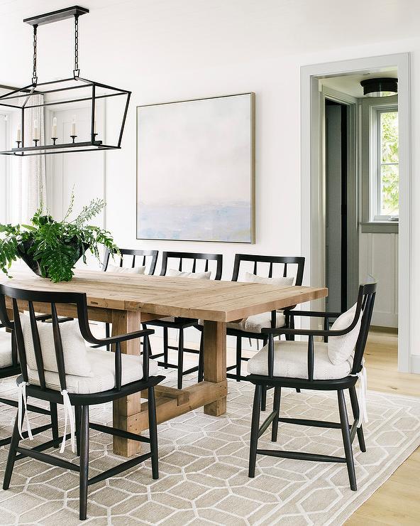 Beige Wood Plank Dining Table with Black Wooden Chairs .