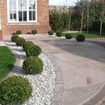 low maintenance landscape - and well draining driveway border .