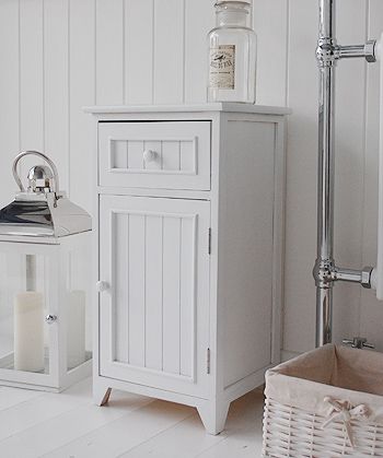 A crisp white freestanding bathroom storage furniture. A narrow .