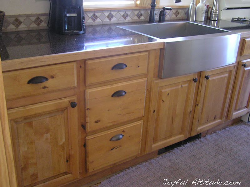 Rustic kitchen, knotty pine kitchen cabinets, stainless steel .