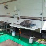 He built an outdoor kitchen that mounts to the side of the camper .