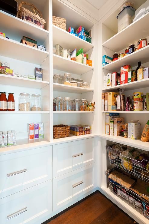 Fabulous walk-in pantry features white built-in shelves stacked .