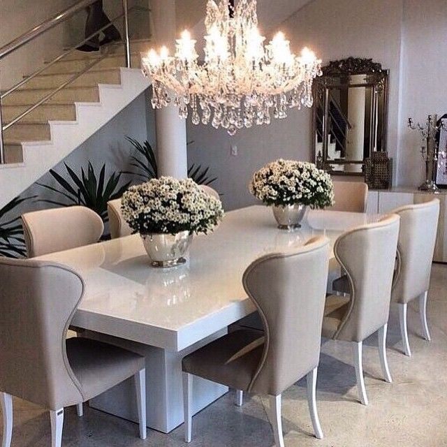 Sleek white table with ivory/beige dining chairs, top off the .