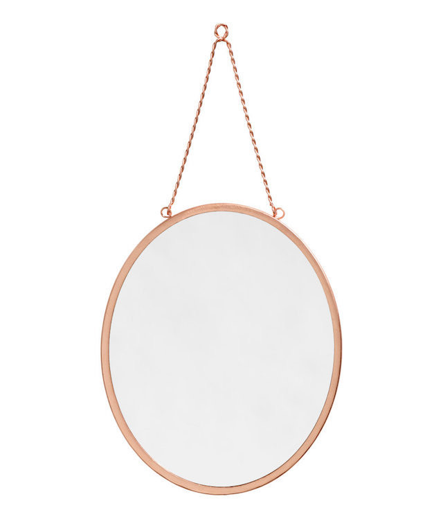 copper-colored oval wall mirror