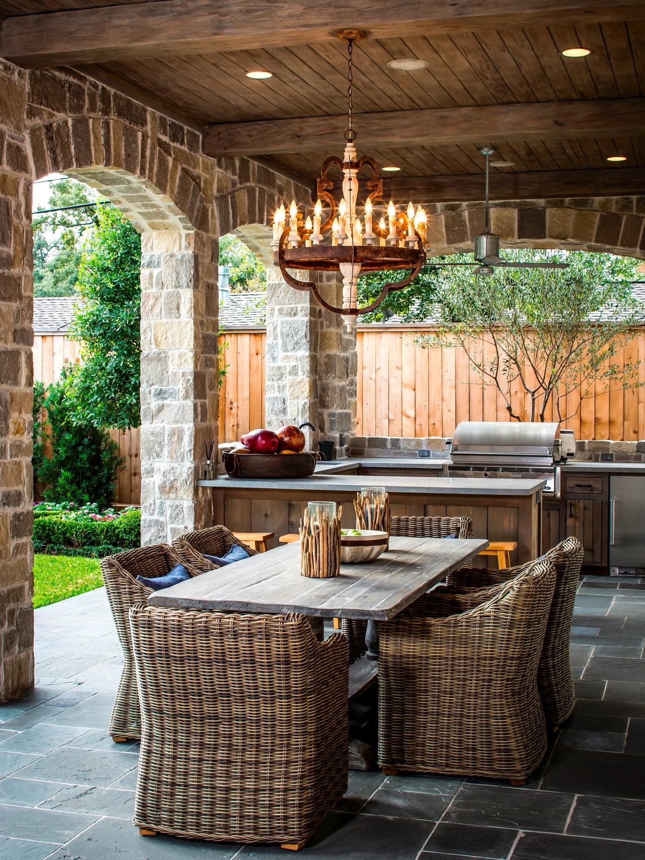 Chandelier outdoor dining area wicker chairs