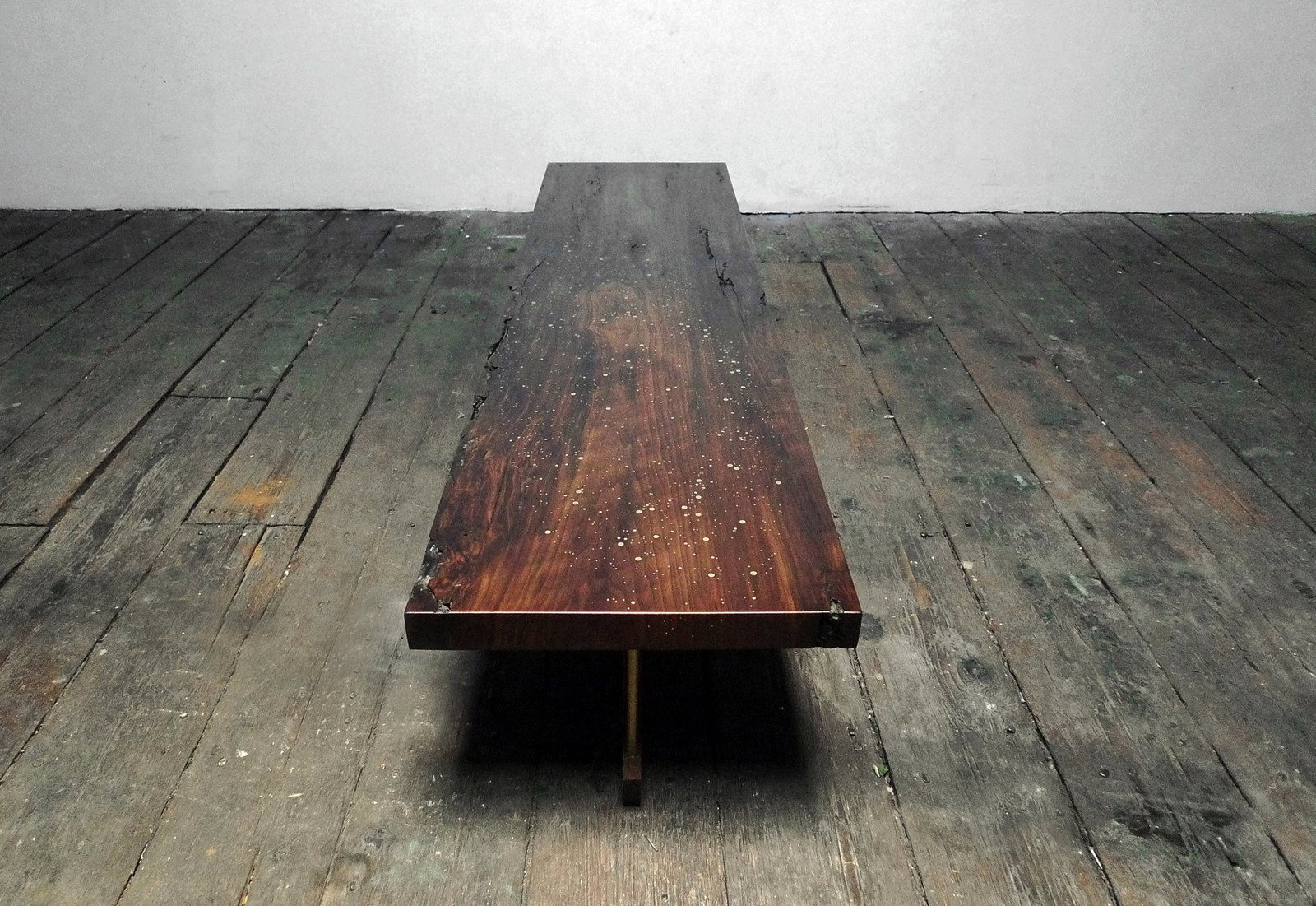 Wooden dining table with brass rivets