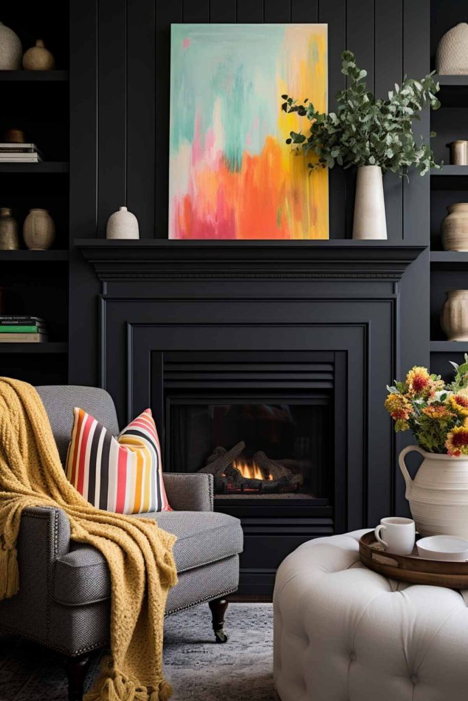 a living room with an all-black fireplace in front of a black wall and a brightly colored abstract painting on the mantel