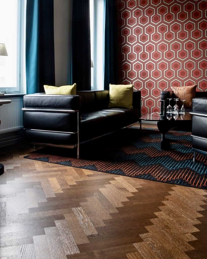 Brown wood herringbone flooring with retro decor