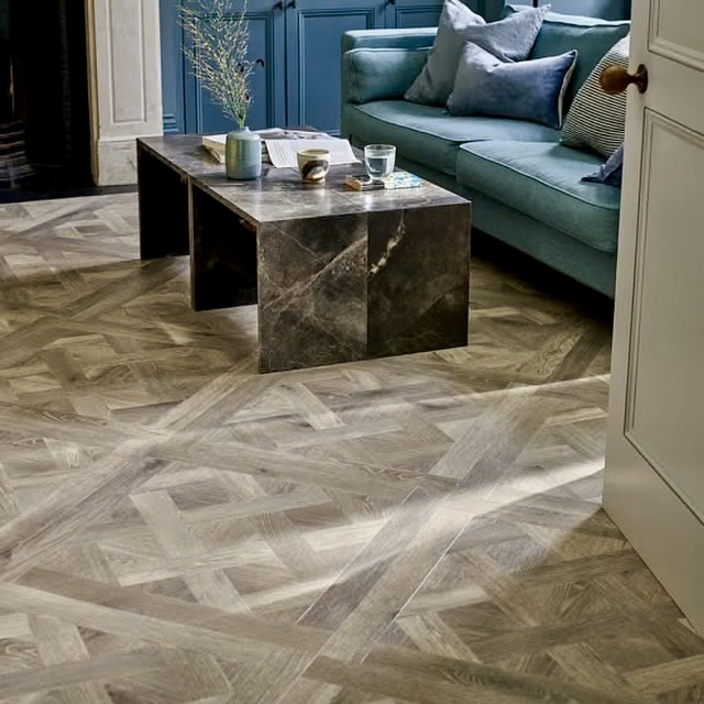 Chevron and diamond patterned gray wood flooring