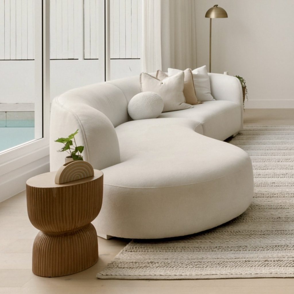 White sofa with rounded edges and warm cushions