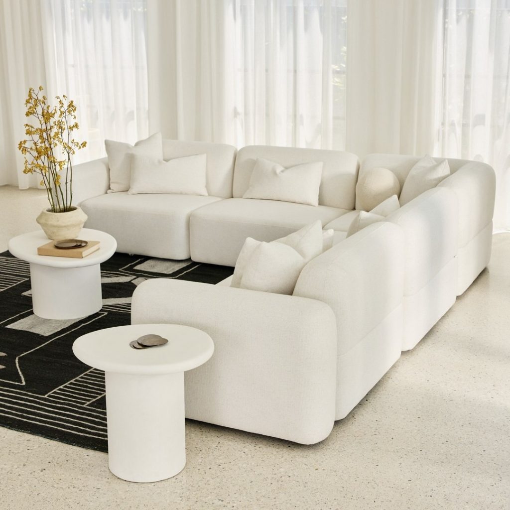 White sectional sofa with black and white rug