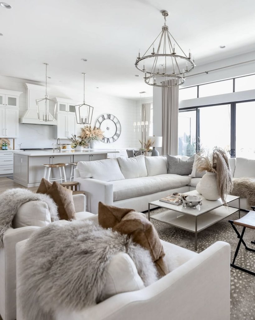 White sofa in open floor plan with neutral cushions and clear table