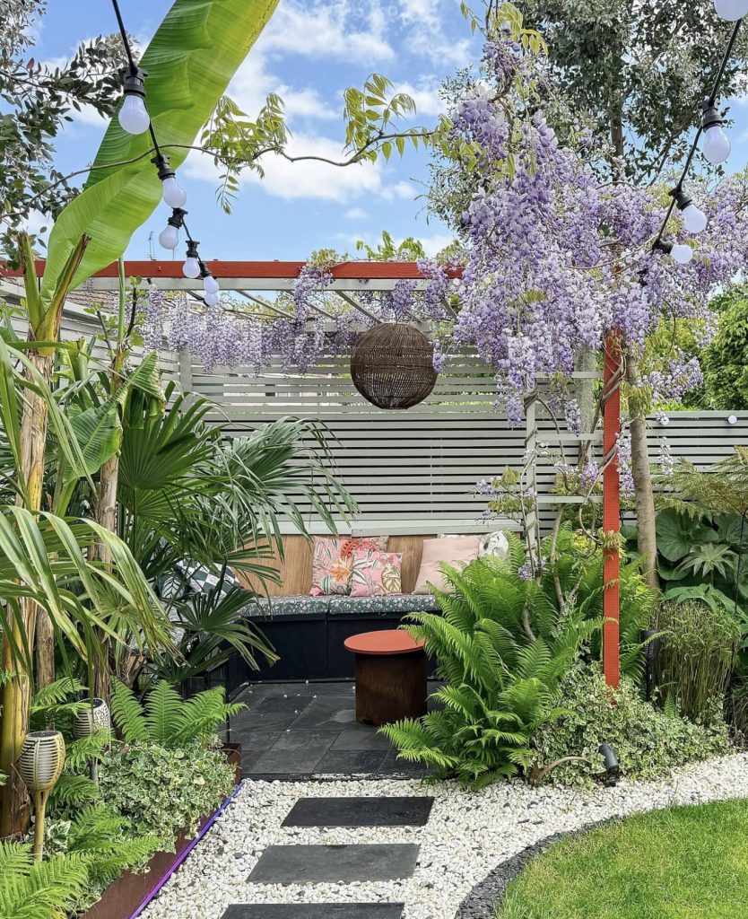 Tropical garden with painted horizontal fence