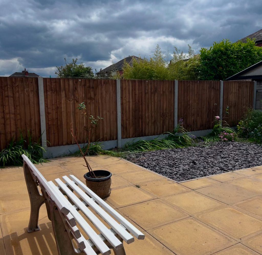 Stained timber fence with concrete posts