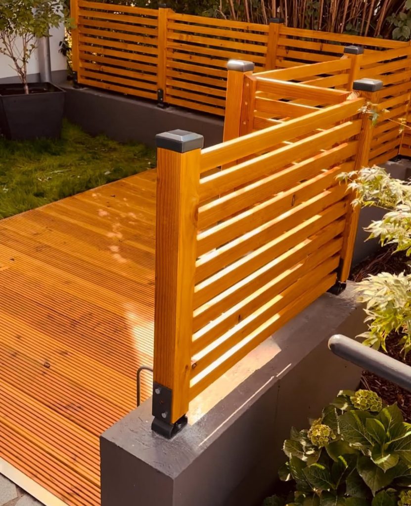 Bright slatted fence with minimalist gate