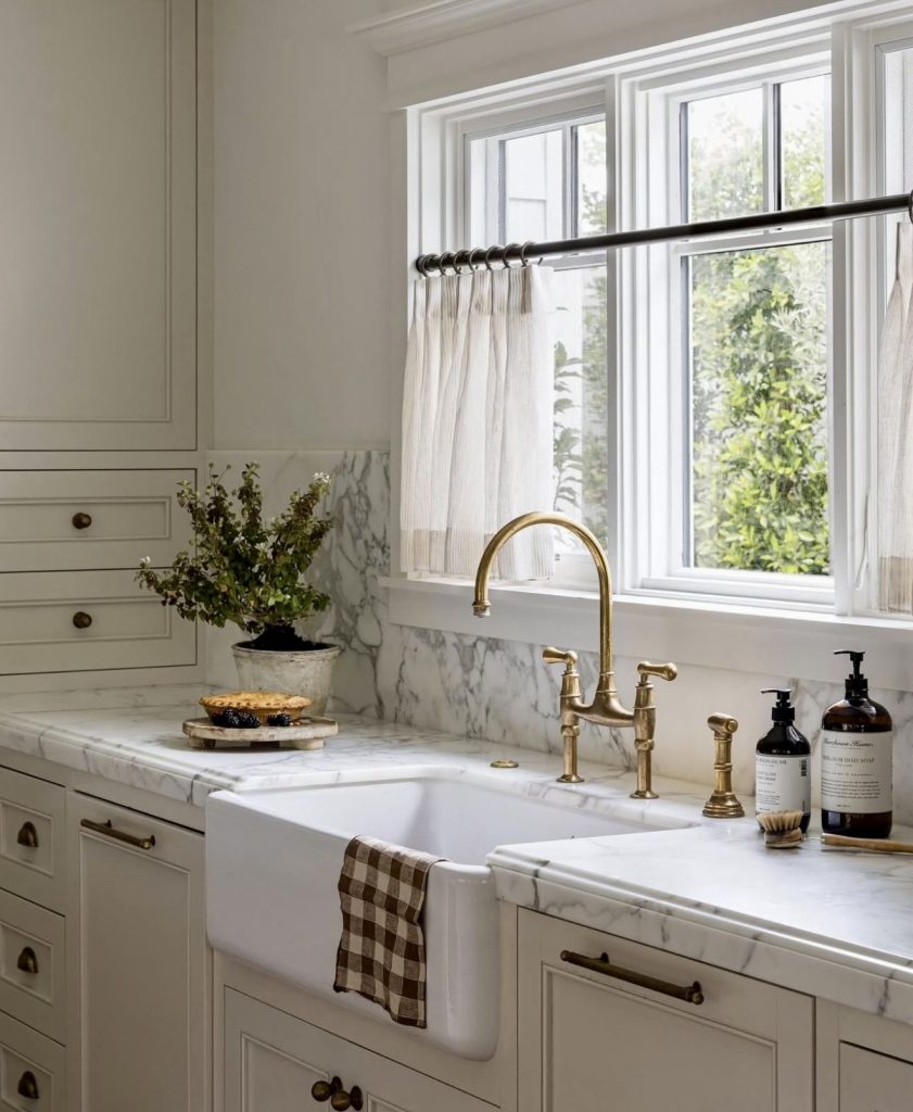 Classic Kitchen with Marble Countertops and Brass Fixtures