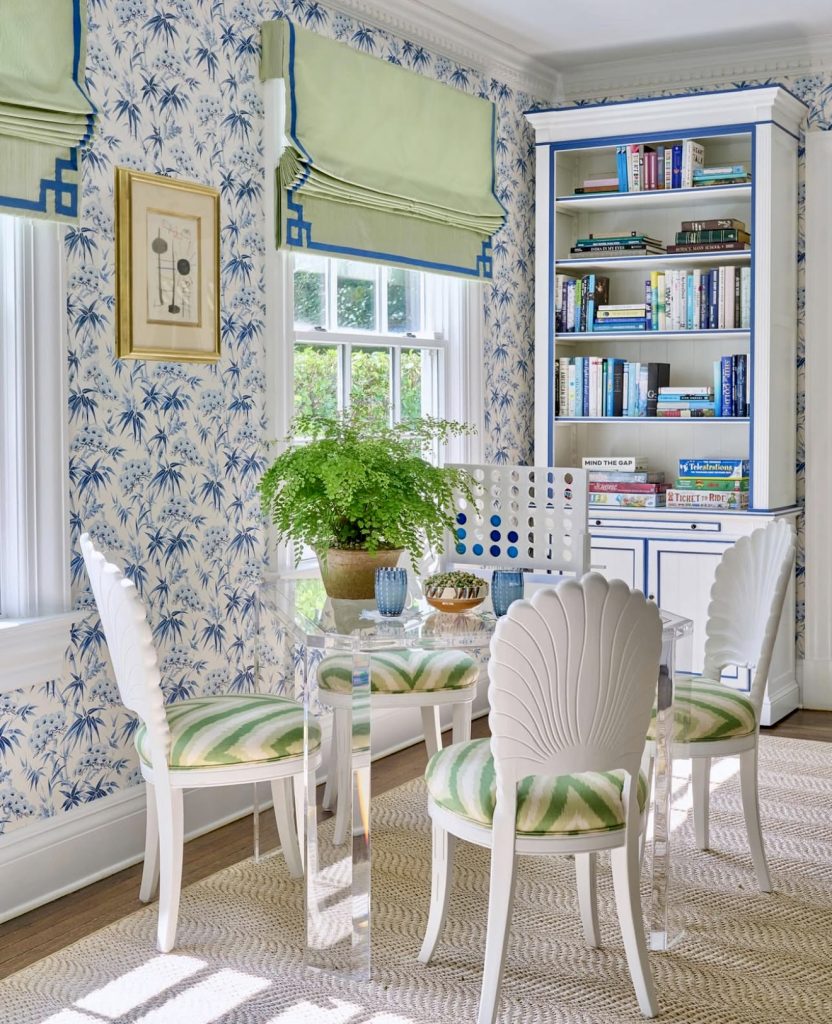 Reading nook with blue palm print wallpaper