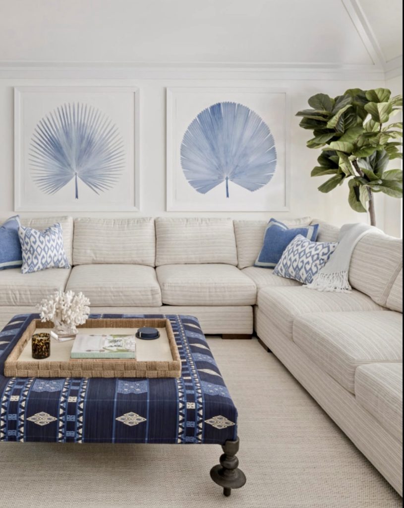 Blue and white living room with striped sectional and global ottoman