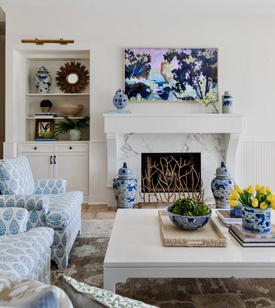 Room with white walls, blue and green accents, and abstract art