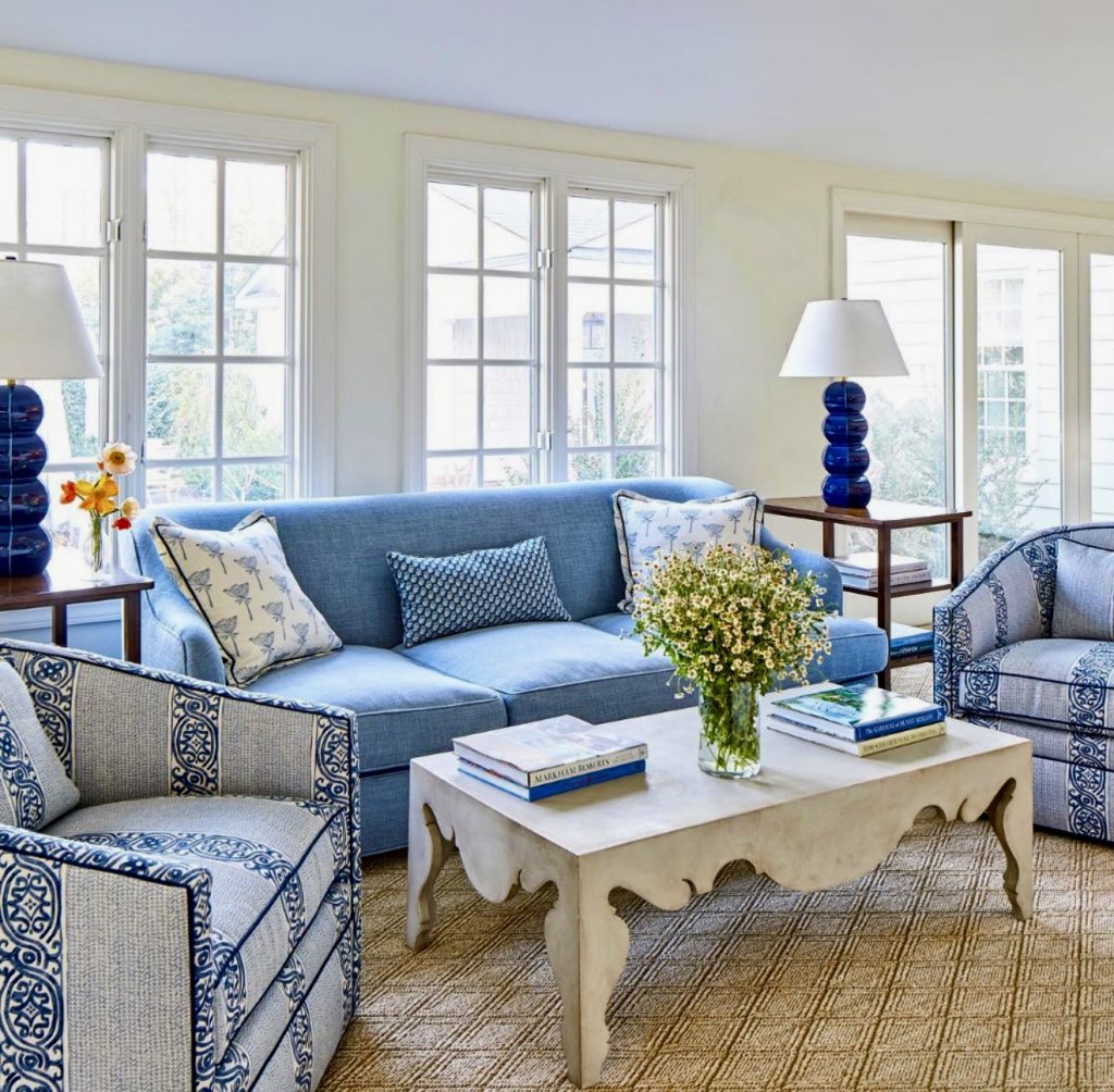 Indigo sofa with patterned armchairs and scalloped coffee table