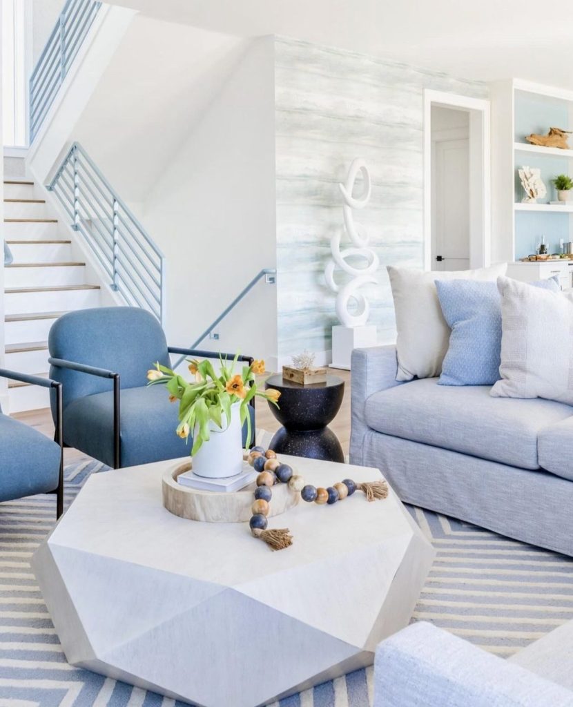 Bright room with geometric coffee table and striped rug