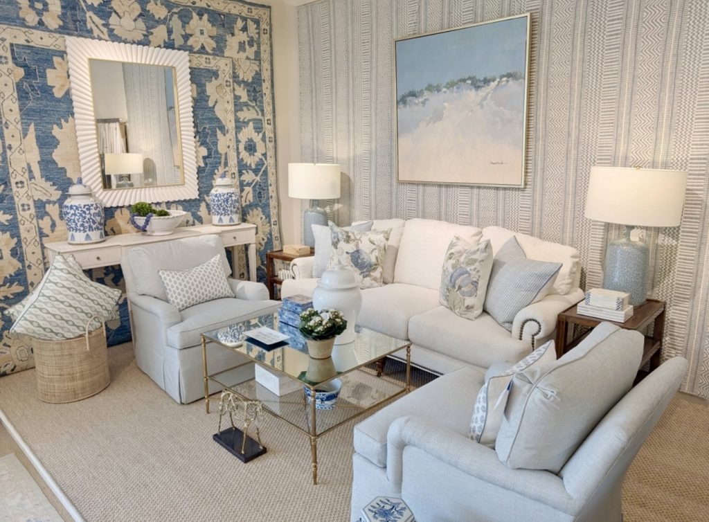 Blue area rug with botanical pillows and mirrored coffee table