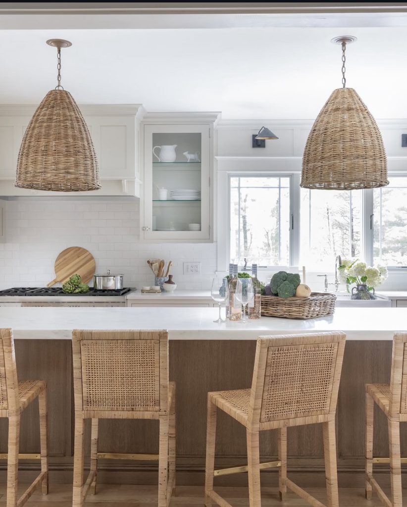 Coastal kitchen with rattan pendants and white subway tile backsplash