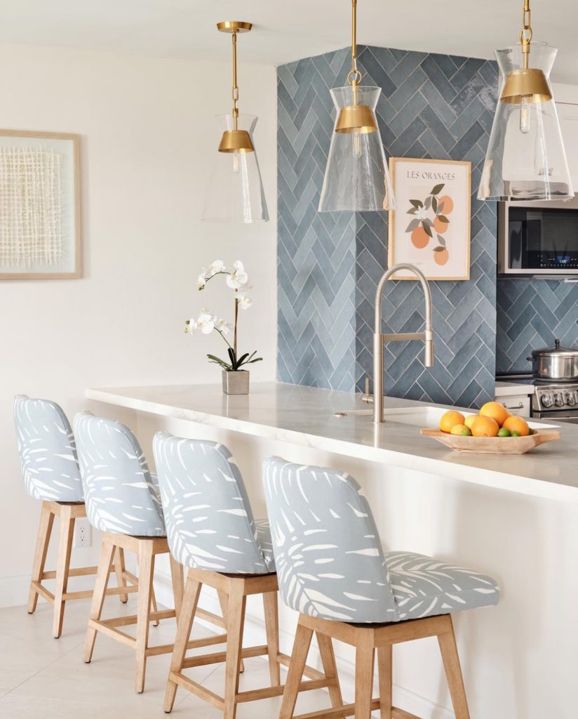 Kitchen with herringbone backsplash and patterned barstools