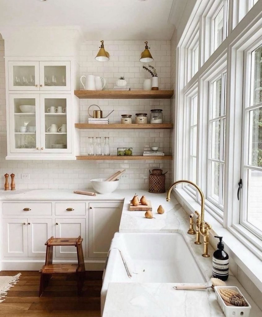 Farmhouse kitchen with white shaker cabinets and wood accents
