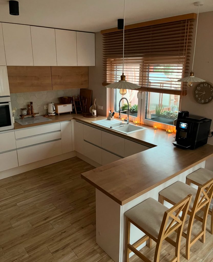 Scandinavian kitchen with white cabinets and butcher block countertops