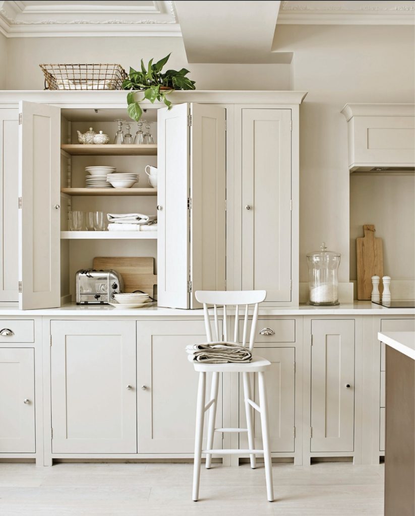 White panel-style cabinetry with silver handles