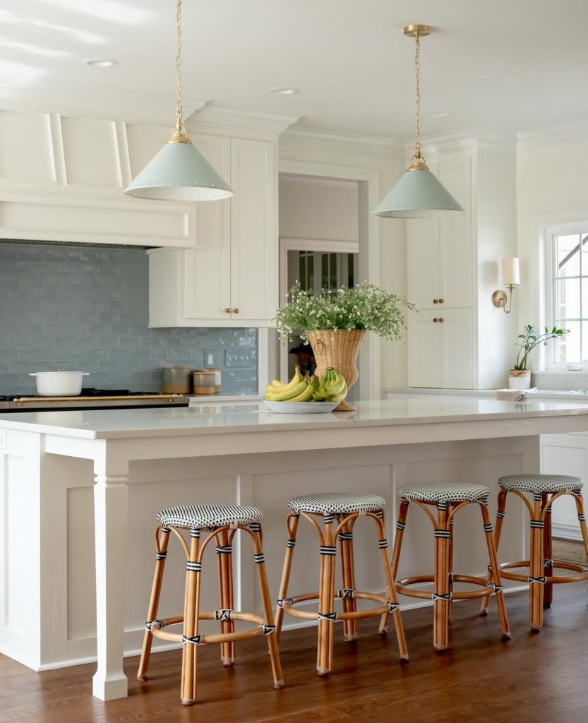 Coastal kitchen with blue backsplash and white cabinets