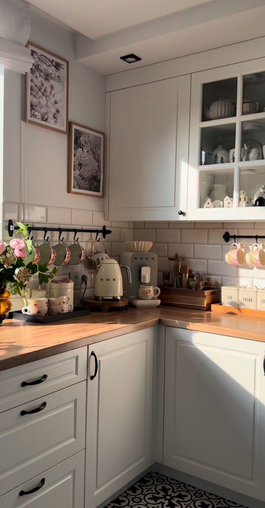 Cottage-style kitchen with white cabinets and butcher block countertop