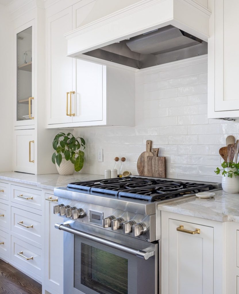 Professional kitchen with tall white cabinets and silver handles
