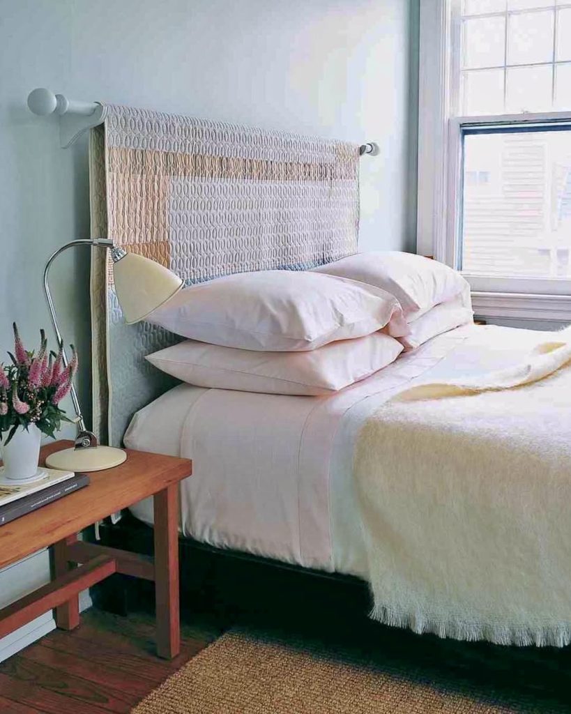 Hanging quilt above bed