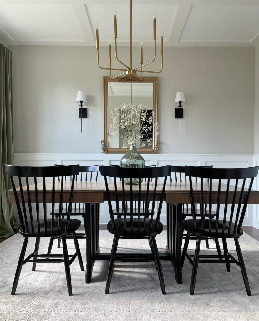 Dining room with mirror and black sconces