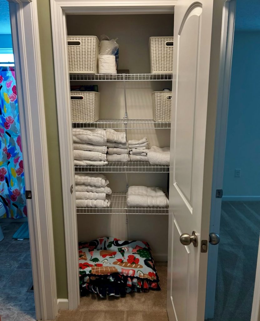 Wire shelving linen closet with woven baskets