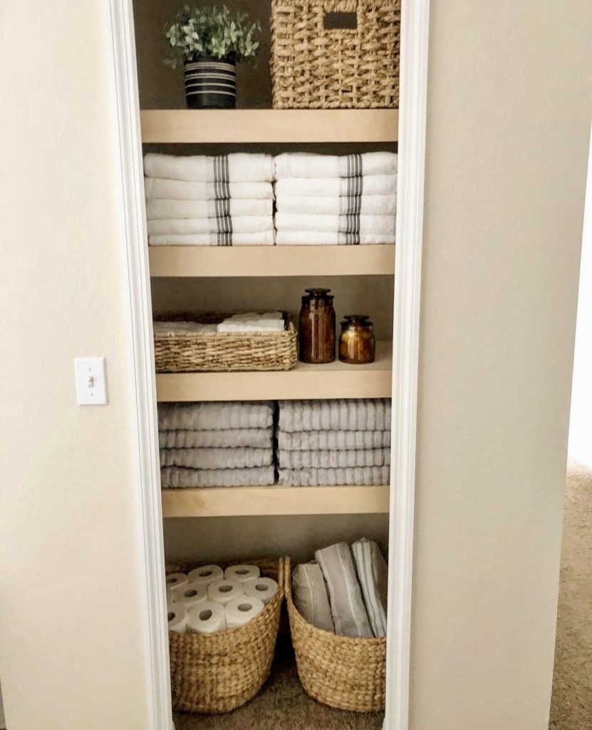 Earthy baskets in linen closet