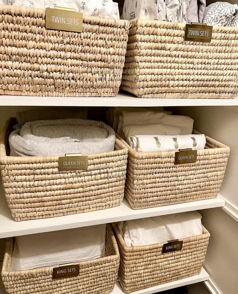 Color-coded labeled baskets in linen closet