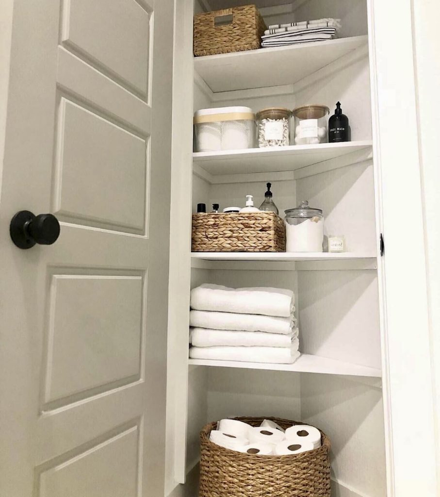 Minimalist linen closet with woven baskets