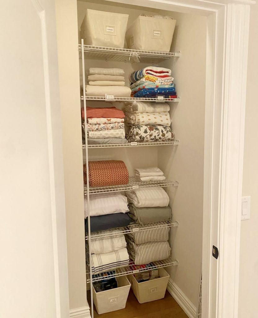 Colorful linen closet with labeled bins