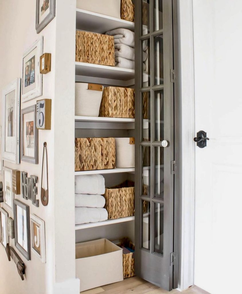 Narrow linen closet with folded towels