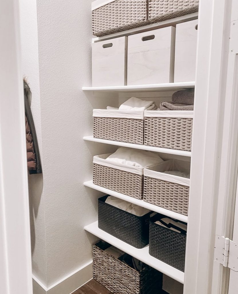 Soft-toned linen closet with woven baskets