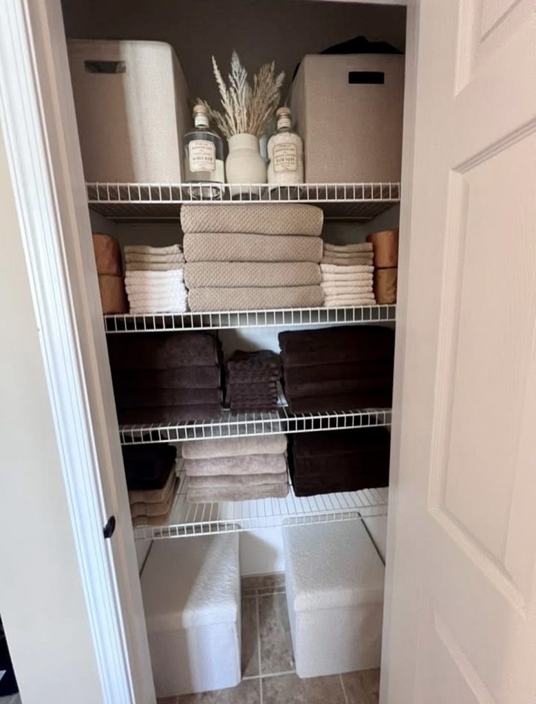Wire shelving with warm neutral linens