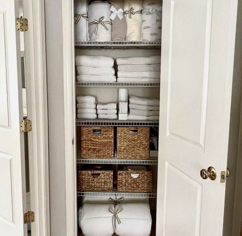 Linen closet with ribbon-wrapped sheets