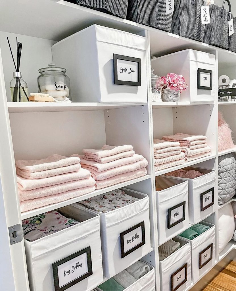 Linen closet with pastel pink towels