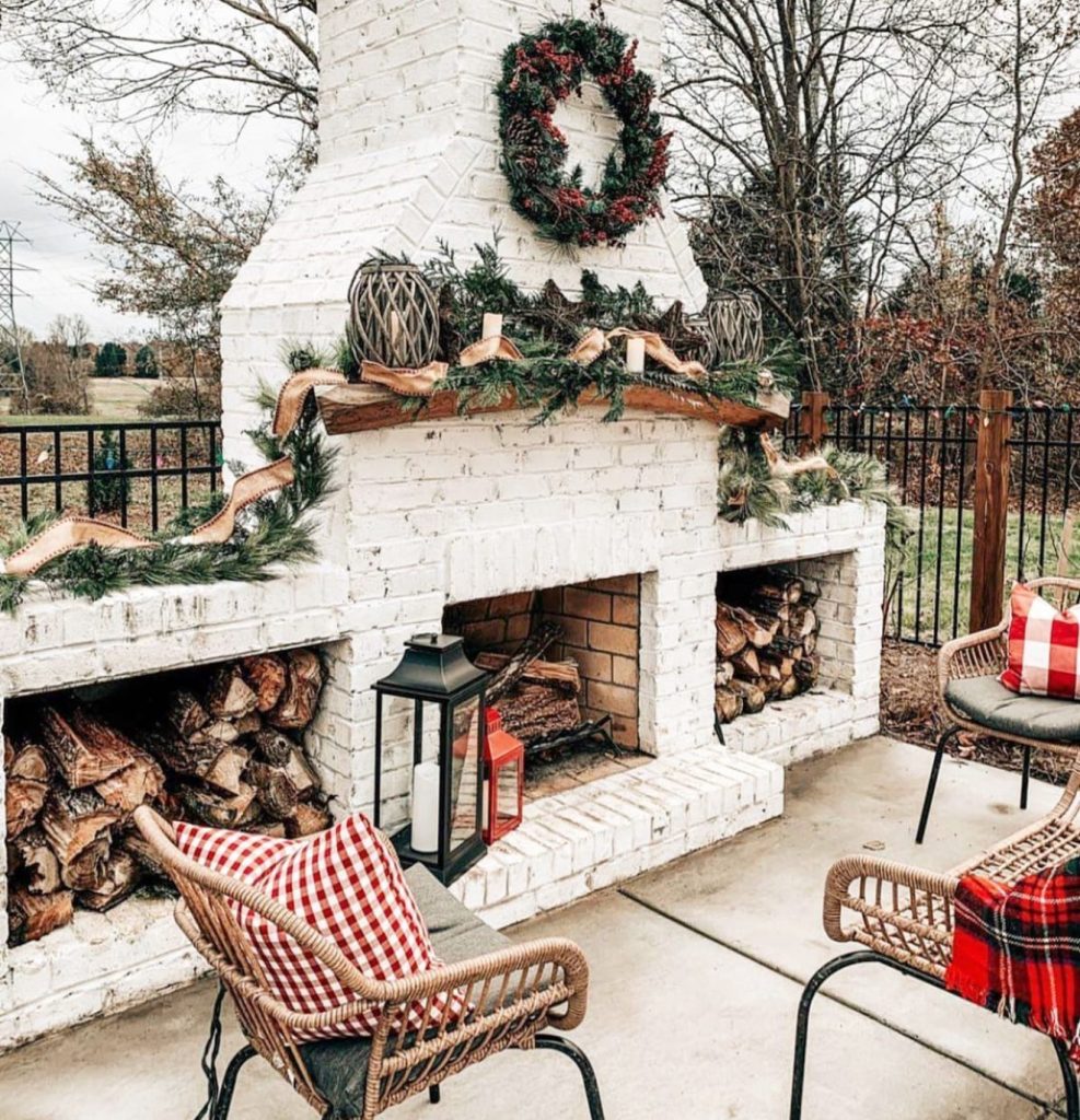 Whitewashed outdoor fireplace with holiday decor
